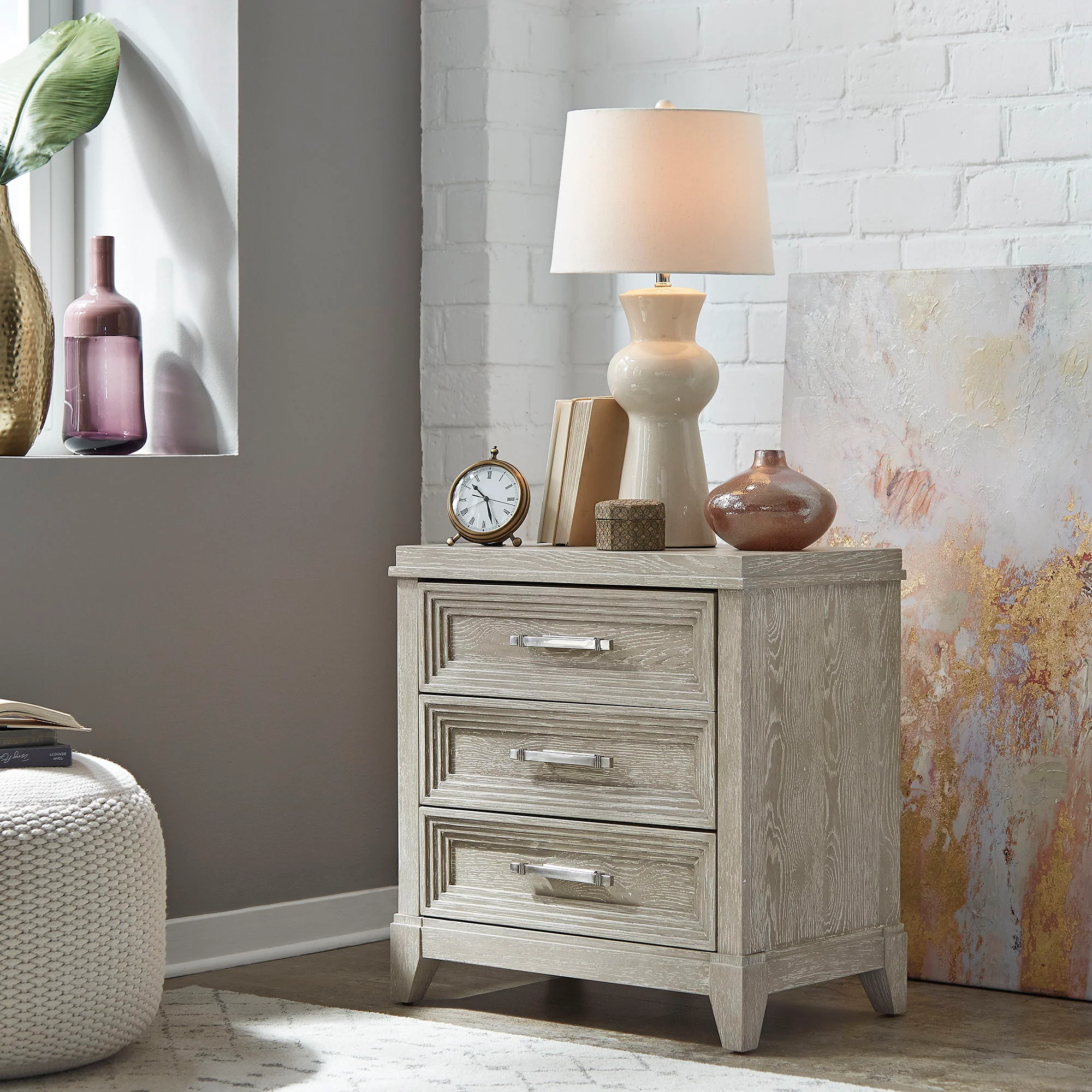 3 Drawer Nightstand - Washed Taupe — Styles are often simplistic with luxury touches such as stainless steel or velvets